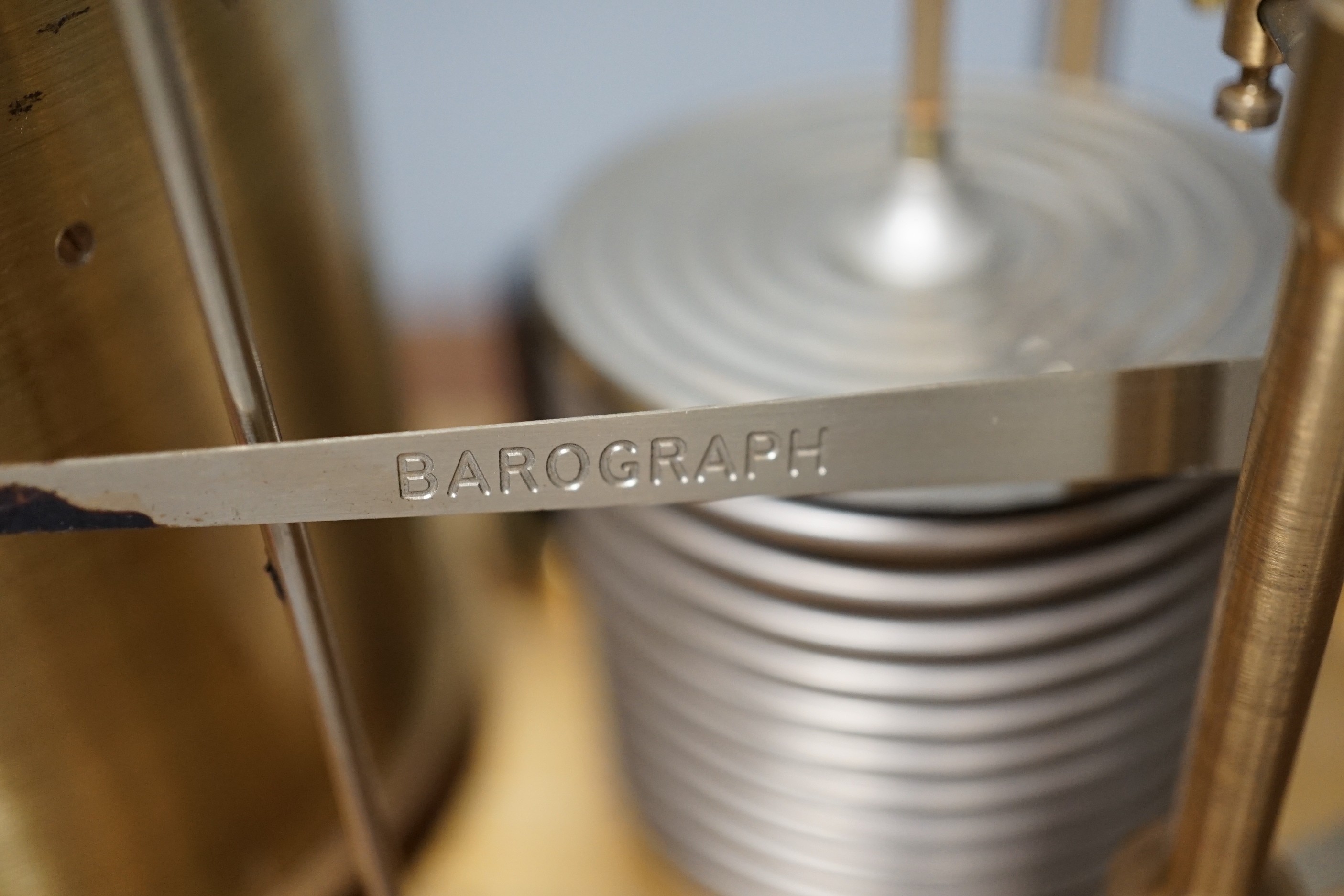 A Negretti & Zambra teak barograph with spare graph paper in case draw. 36cm wide.